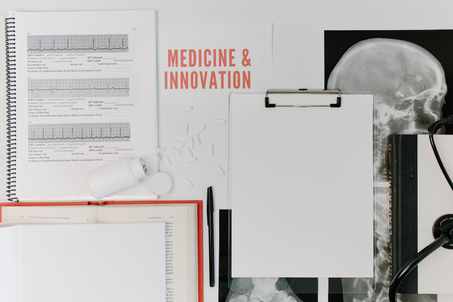 A twenty-pound medicine ball resting on a mattress surface next to a testing notebook