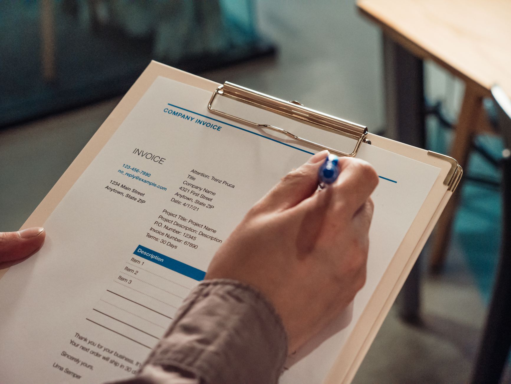close-up of a mattress warranty document with a pen resting on the fine print